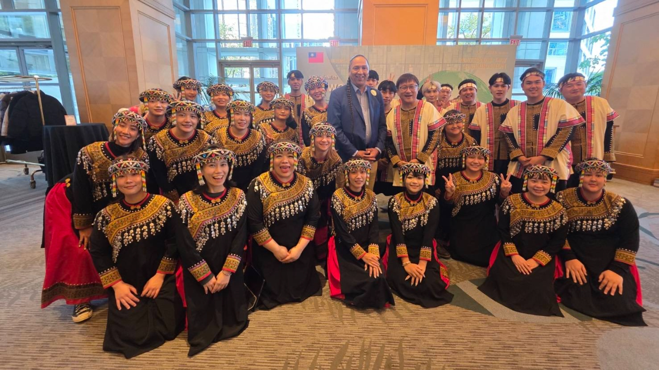 Chief Frank Antoine of Bonaparte First Nation poses with members of the Nibun Chorus after the opening act